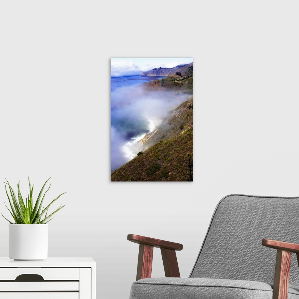 A modern room featuring Photograph of fog rolling in off the California Big Sur ocean hitting the cliffs of the mountains...
