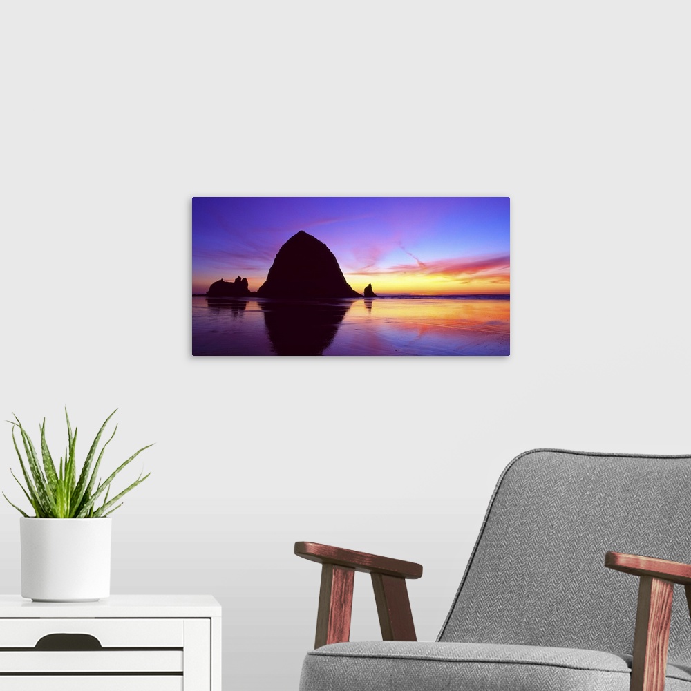 A modern room featuring Sea stacks on the beach silhouetted at sunset, Cannon Beach, Oregon.