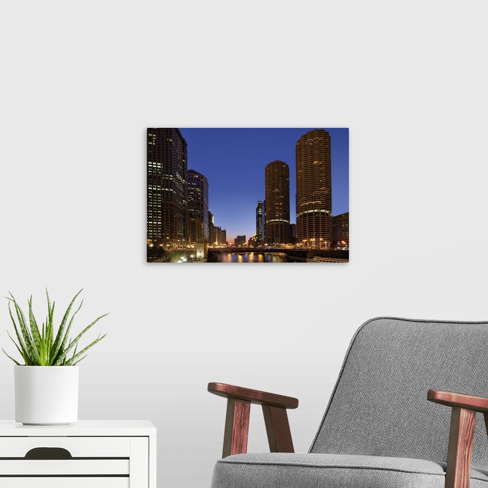 A modern room featuring Dusk scene of Chicago skyline with Marina Towers along river