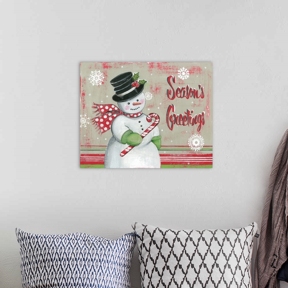 A bohemian room featuring Snowman holiday decor that reads "Season's Greetings" on the side.