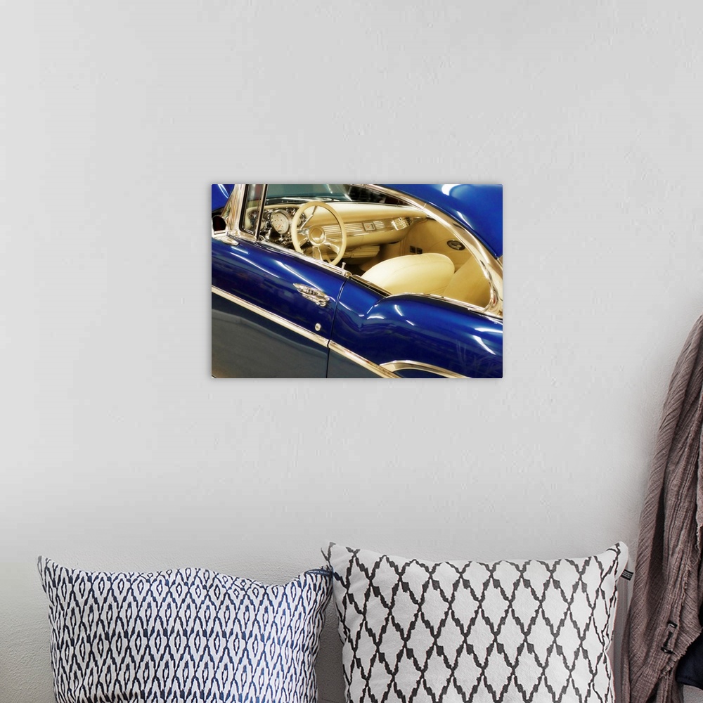 A bohemian room featuring This horizontal photograph is a close up of the interior of an antique car.