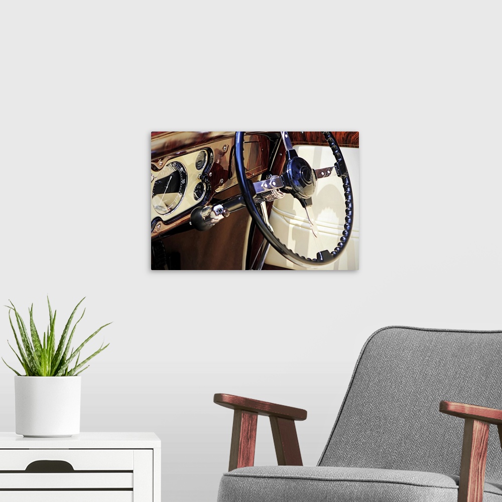 A modern room featuring Large, landscape, close up photograph of the dashboard of a classic car, polished and shining, in...