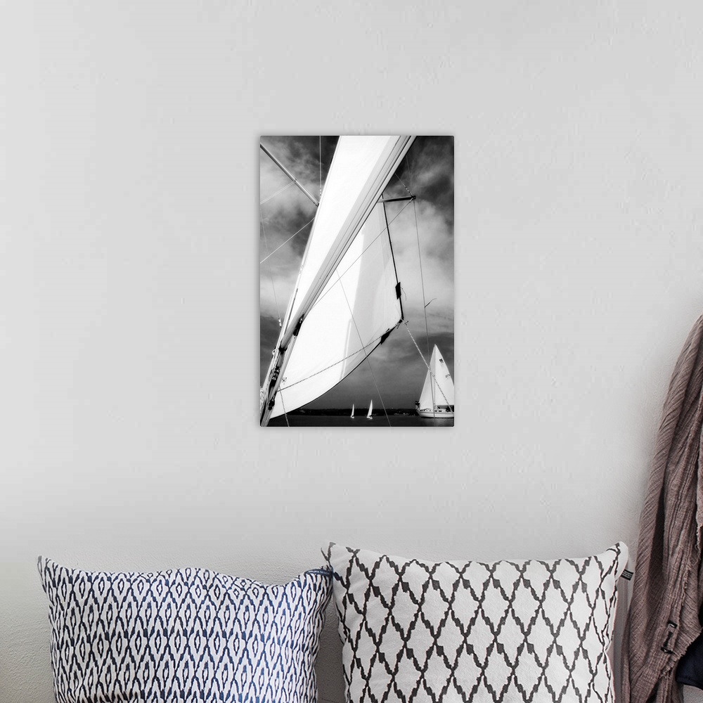 A bohemian room featuring Giant, vertical, close up photograph of a sail blowing in the wind, in front of a cloudy sky.  Se...