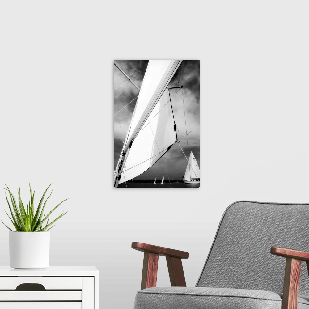 A modern room featuring Giant, vertical, close up photograph of a sail blowing in the wind, in front of a cloudy sky.  Se...