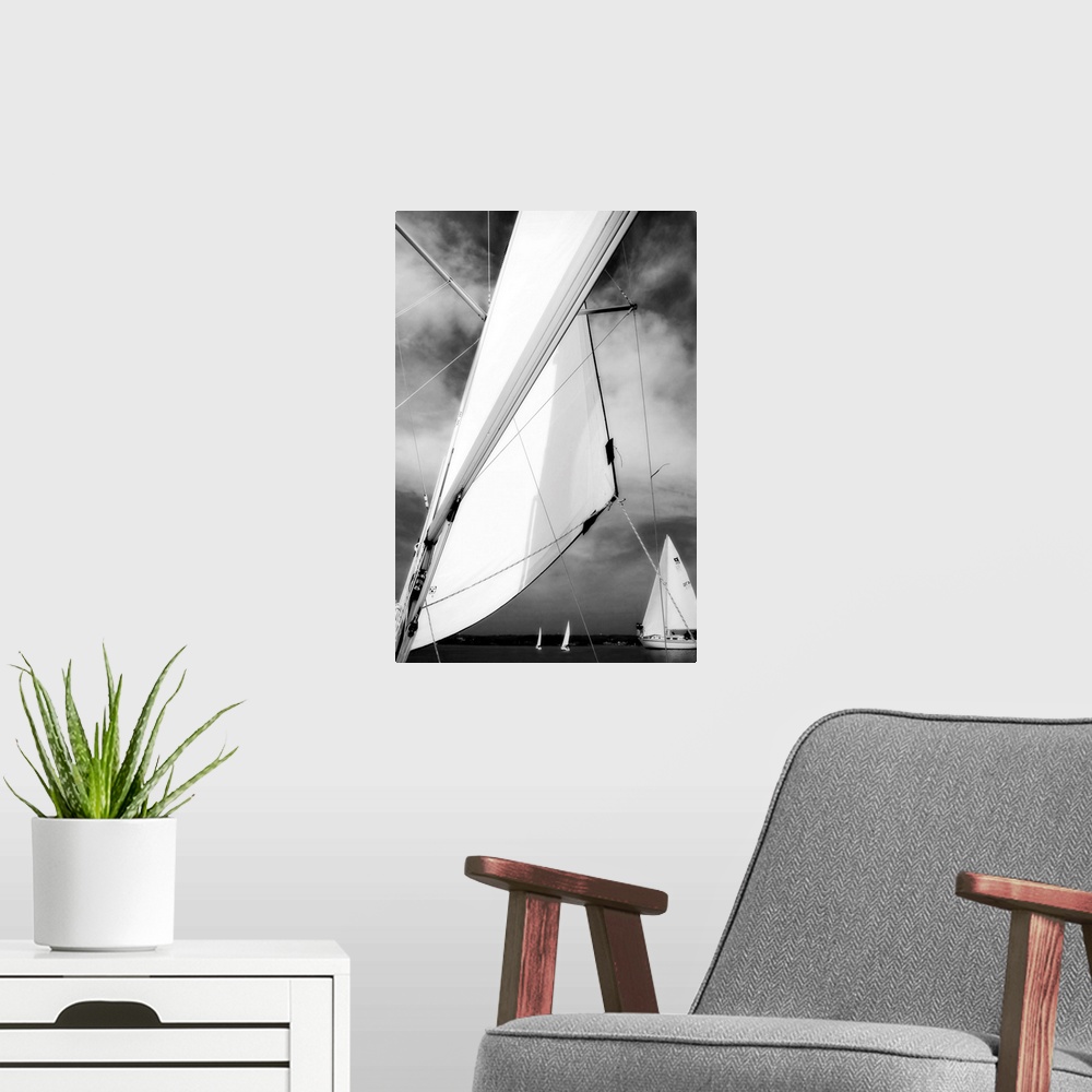 A modern room featuring Giant, vertical, close up photograph of a sail blowing in the wind, in front of a cloudy sky.  Se...