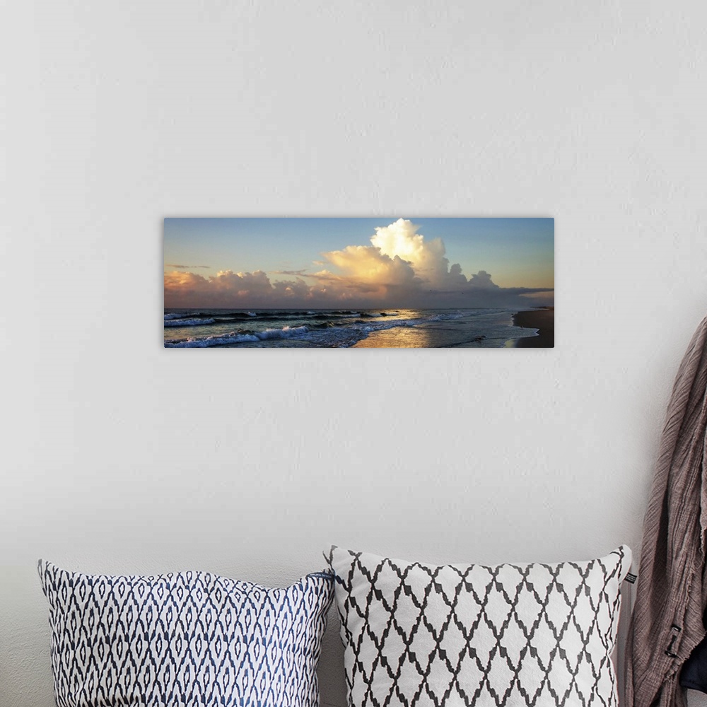 A bohemian room featuring Panoramic photograph of the ocean at sunrise with fluffy clouds in the sky and shorebirds in the ...