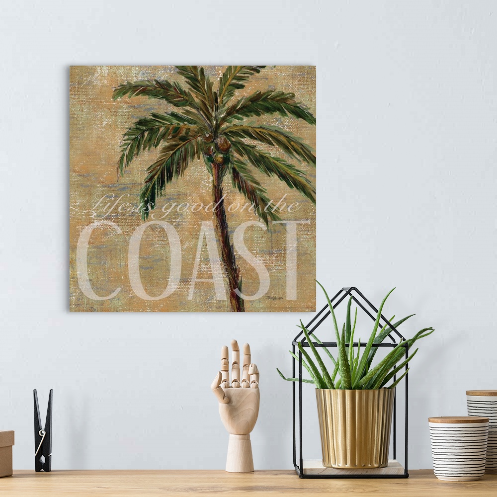 A bohemian room featuring Neutral toned square beach decor with a painting of a palm tree and "Life is good on the Coast" w...
