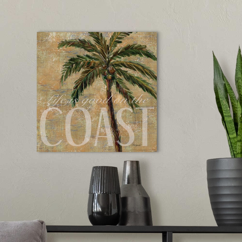 A modern room featuring Neutral toned square beach decor with a painting of a palm tree and "Life is good on the Coast" w...
