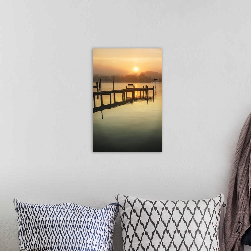 A bohemian room featuring Silhouetted pier on a calm ocean in orange sunrise light.