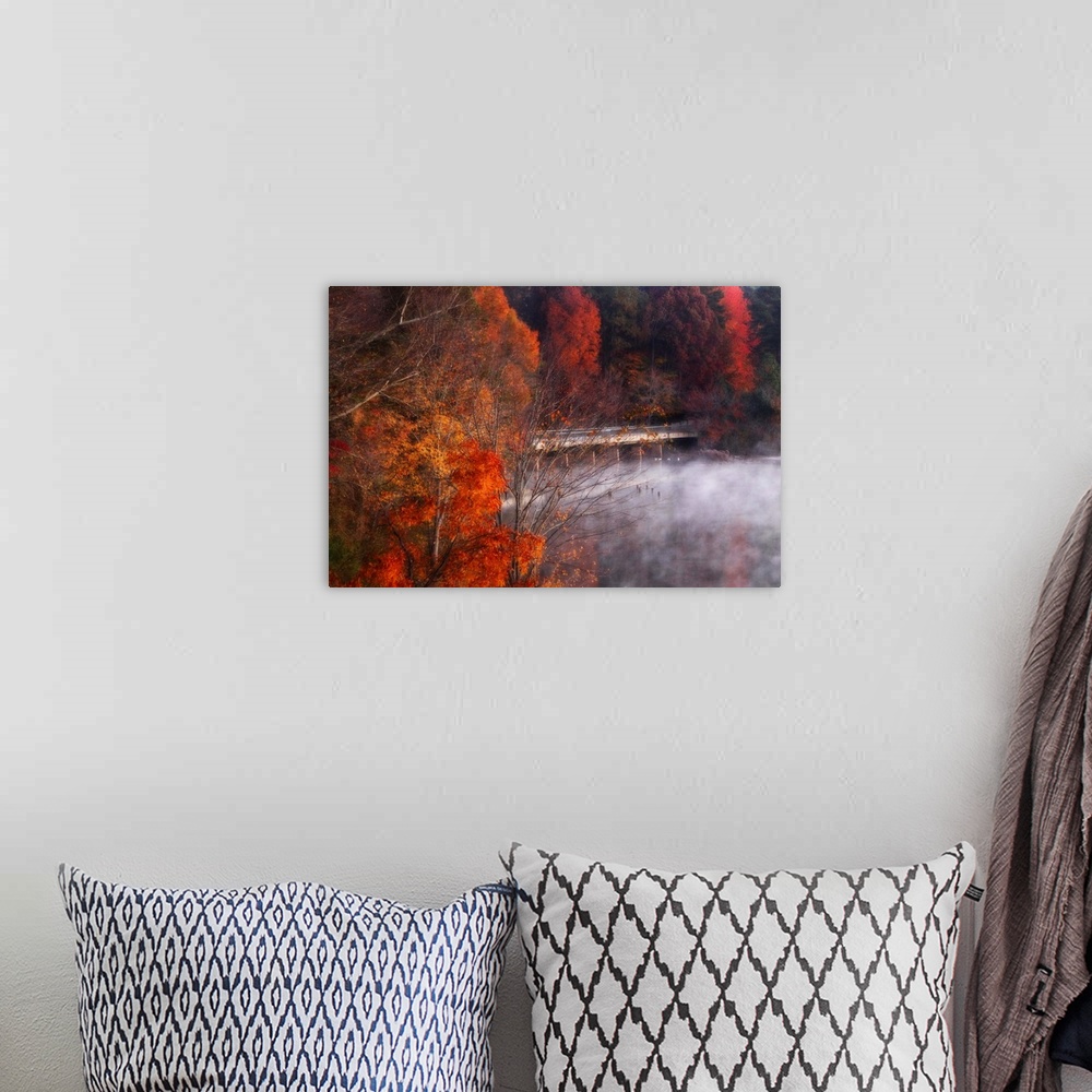 A bohemian room featuring Landscape photograph on a big canvas of a low mist hanging over the water, beneath a bridge surro...