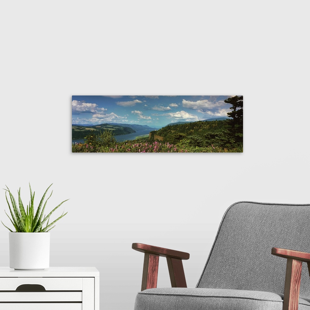A modern room featuring A bright blue sky with clouds over the Columbia River Gorge.