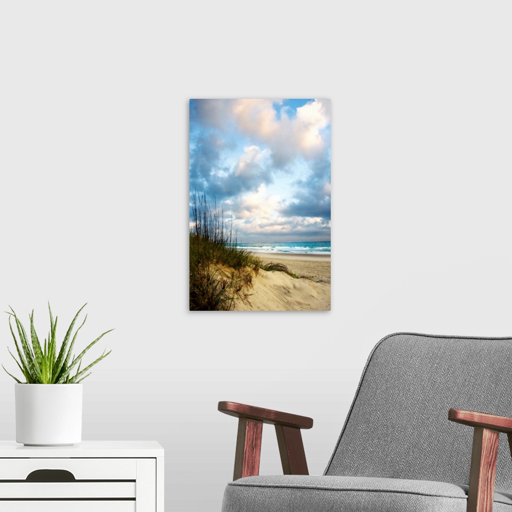 A modern room featuring Giant photograph taken of an ocean as it gently crashes into the sandy beach on a sunny day.  Loc...