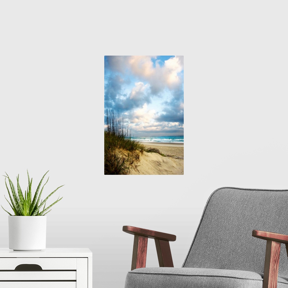 A modern room featuring Giant photograph taken of an ocean as it gently crashes into the sandy beach on a sunny day.  Loc...