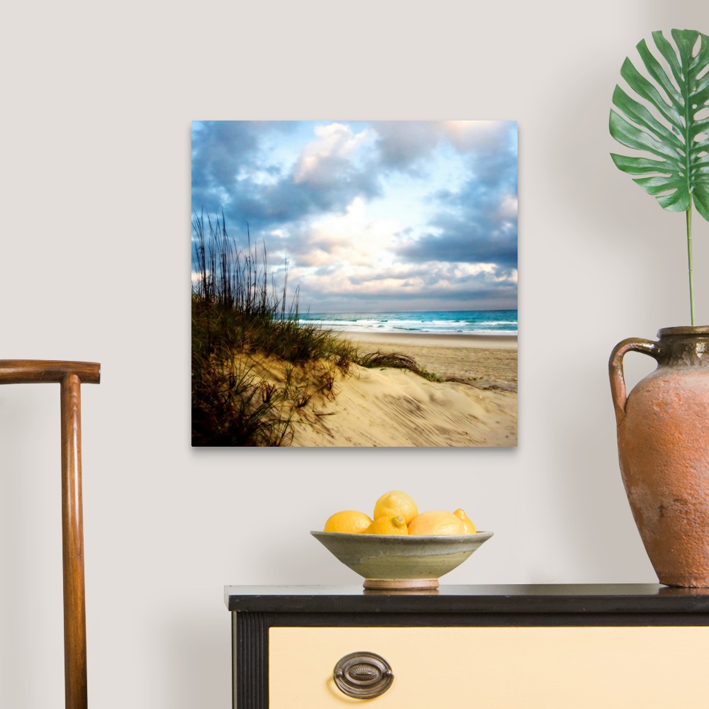 A traditional room featuring Soft focus fine art photo of sand dune covered in reeds on the beach as blue water crashes on the...