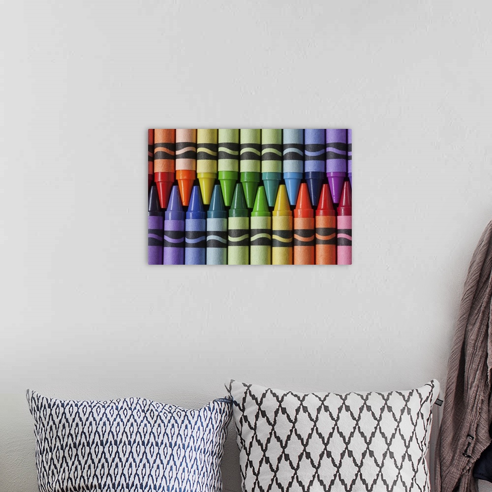 A bohemian room featuring Crayons arranged in colors of a rainbow