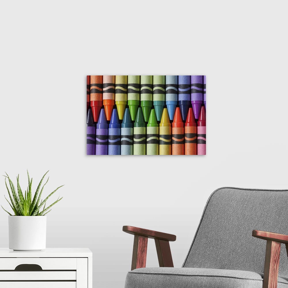 A modern room featuring Crayons arranged in colors of a rainbow