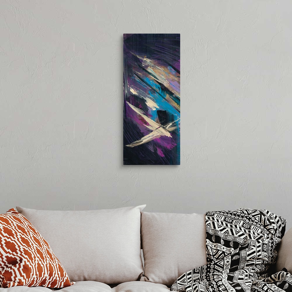 A bohemian room featuring Panel abstract painting with a dark black background and bright purple, pink, blue, and tan brush...