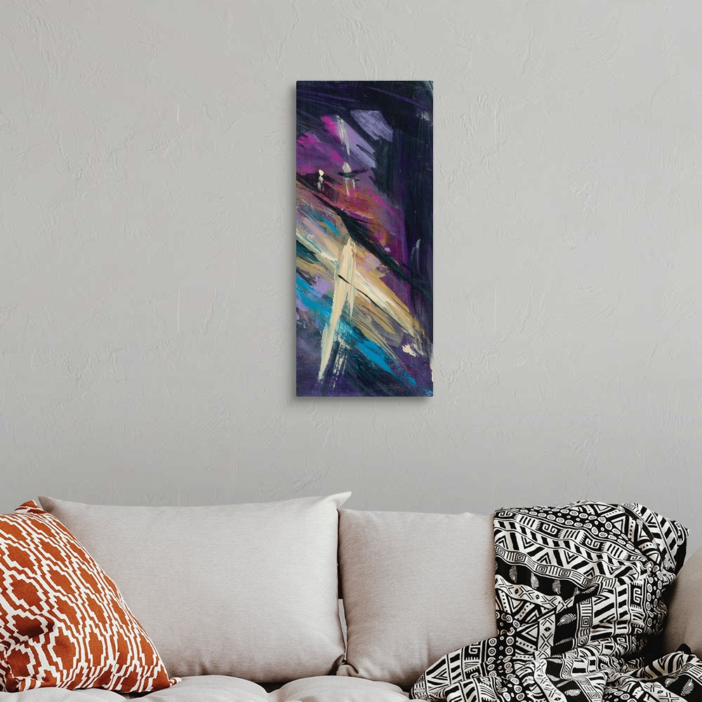 A bohemian room featuring Panel abstract painting with a dark black background and bright purple, pink, blue, and tan brush...