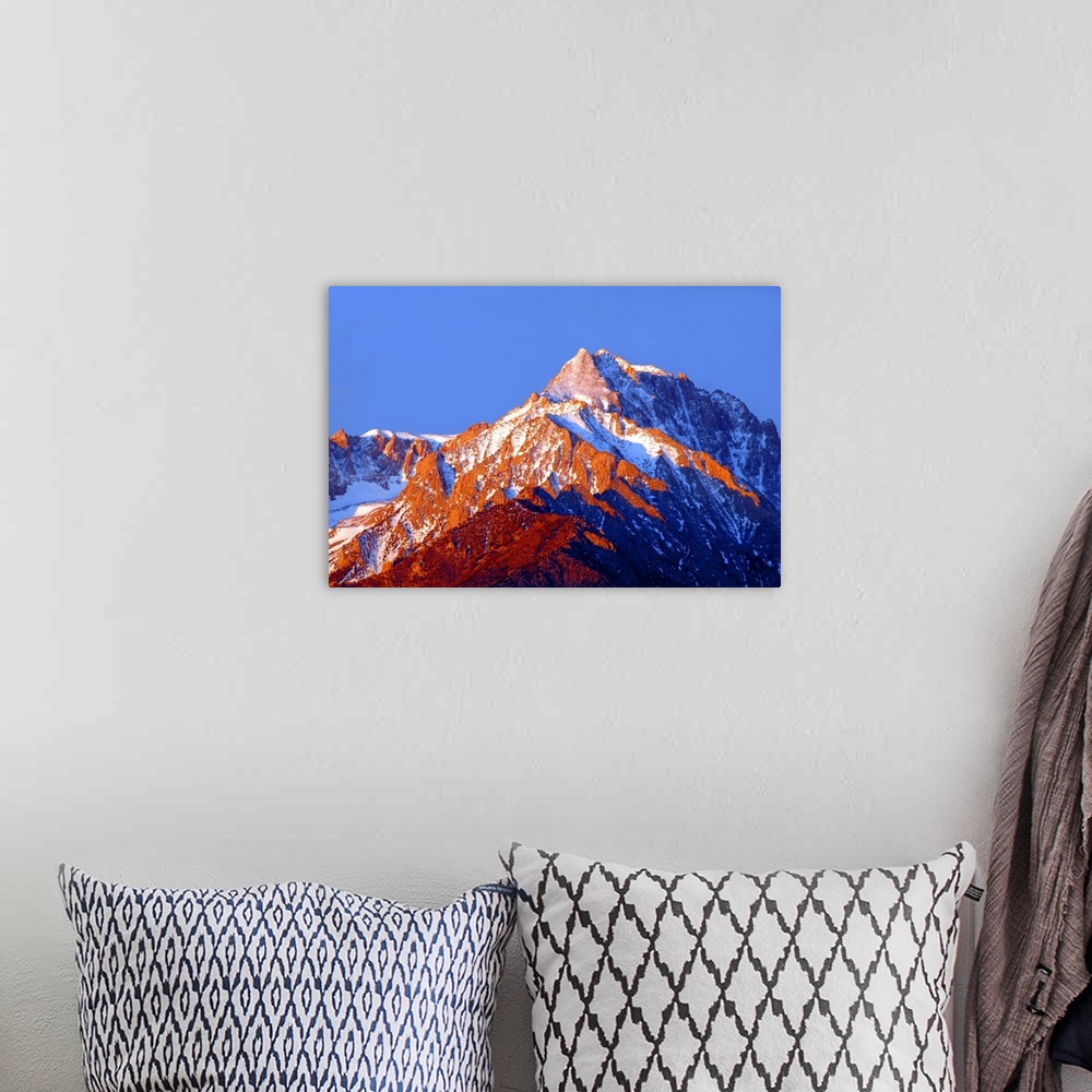 A bohemian room featuring Photograph of Mount Williamson with golden lit snowy peaks at sunrise.