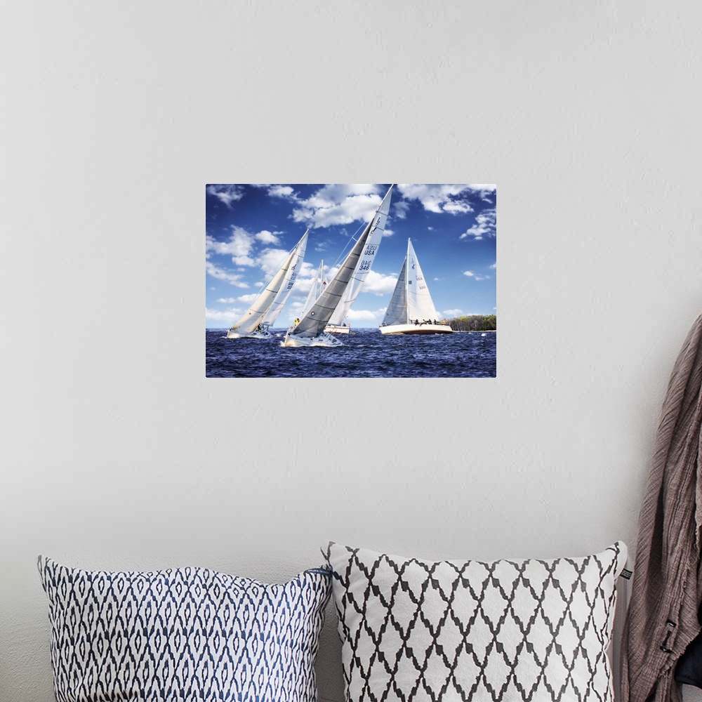 A bohemian room featuring Three white sailboats on the water under a cloudy blue sky.