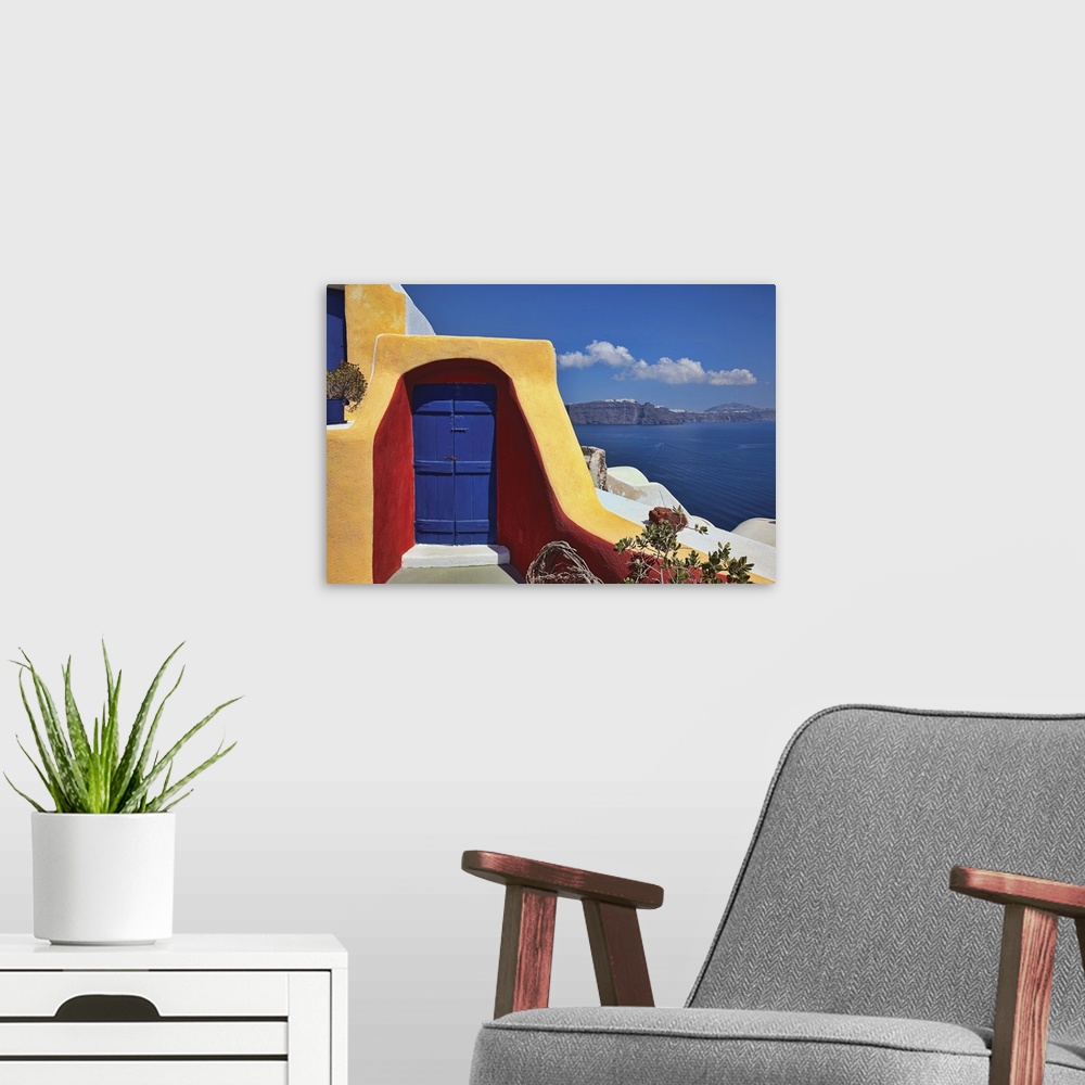 A modern room featuring Photo on canvas of a doorway of a house on a cliff overlooking the ocean.