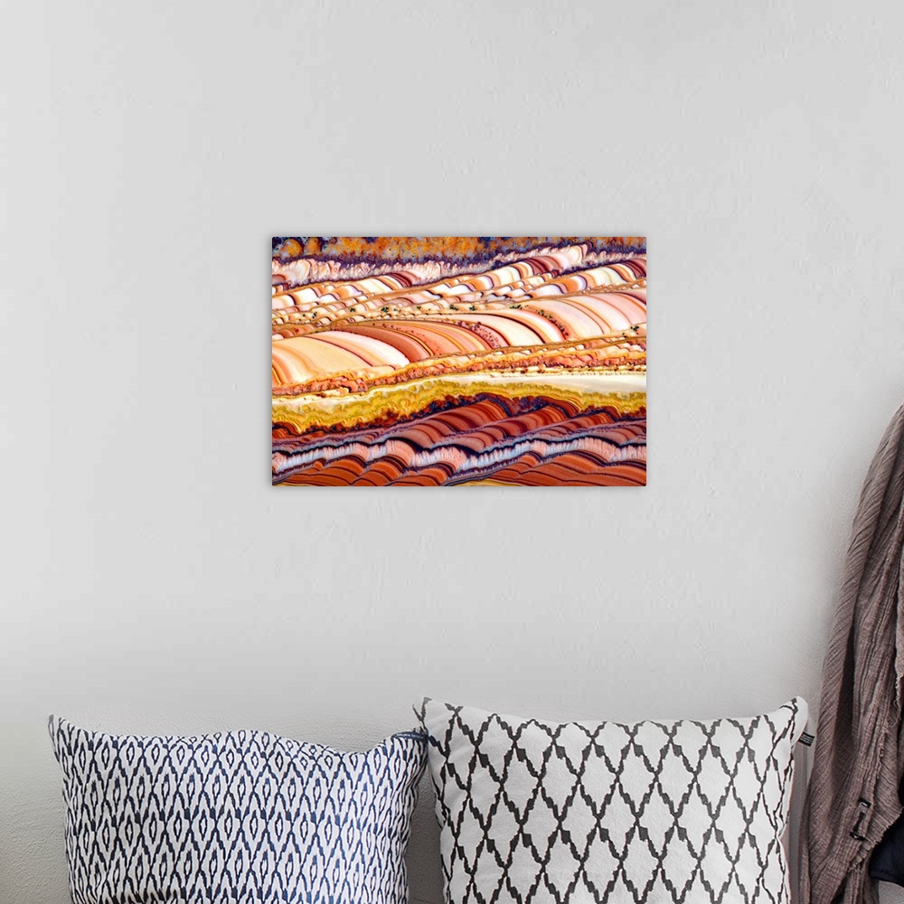 A bohemian room featuring Abstract photograph resembling colorfully striped rolling hills.