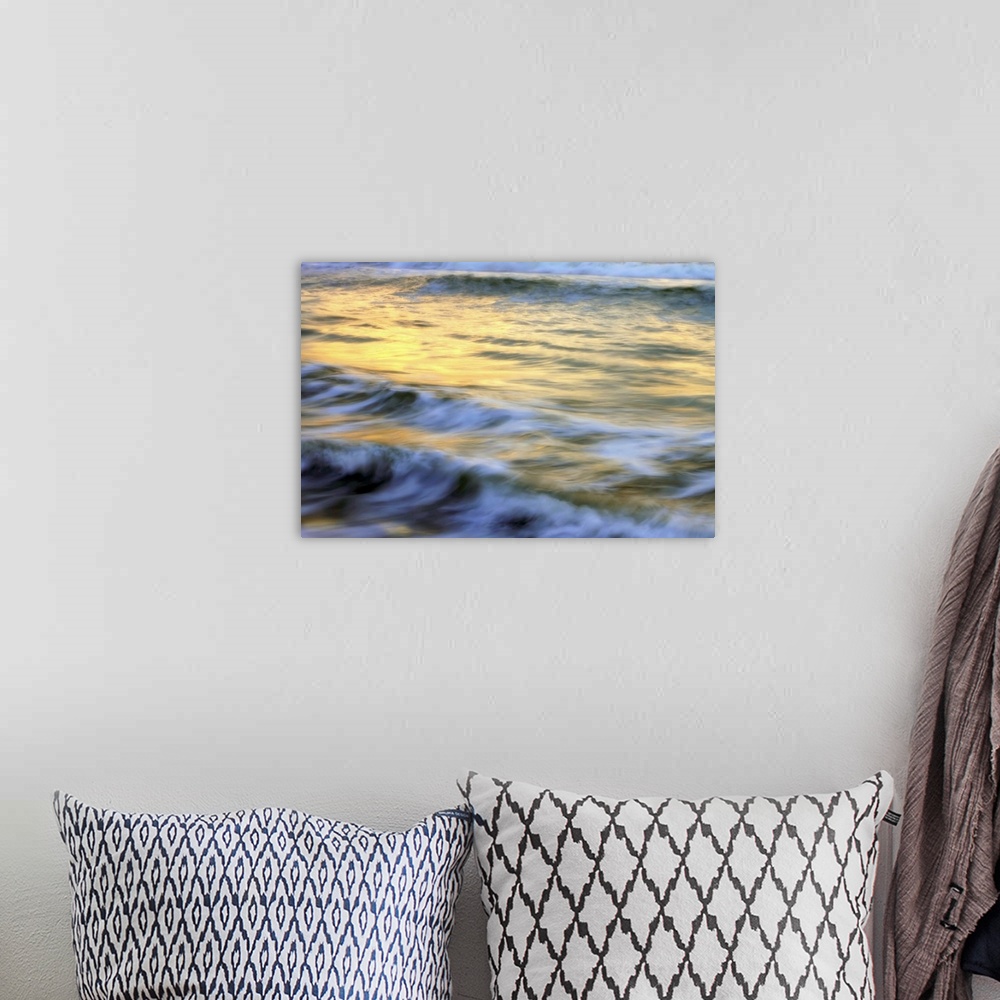 A bohemian room featuring Soft photograph of a sunset reflecting light on the ocean waves.