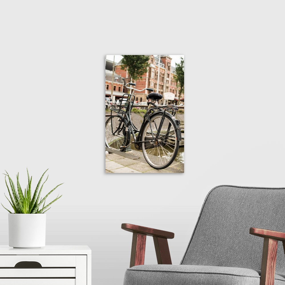 A modern room featuring A bicycle leaning against a railing in the Netherlands.