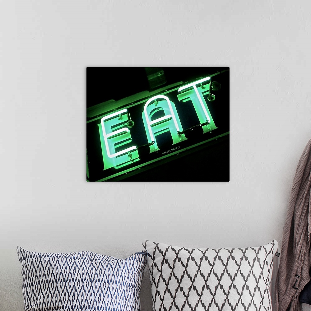 A bohemian room featuring Photograph of a green neon sign lit up at night that reads "EAT"
