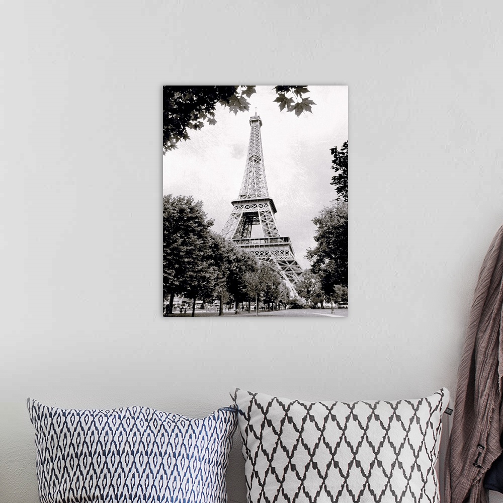 A bohemian room featuring Large vertical black-and-white photograph of the Eiffel Tower in Paris, France.
