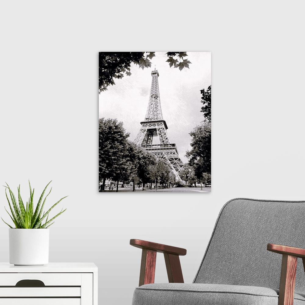 A modern room featuring Large vertical black-and-white photograph of the Eiffel Tower in Paris, France.