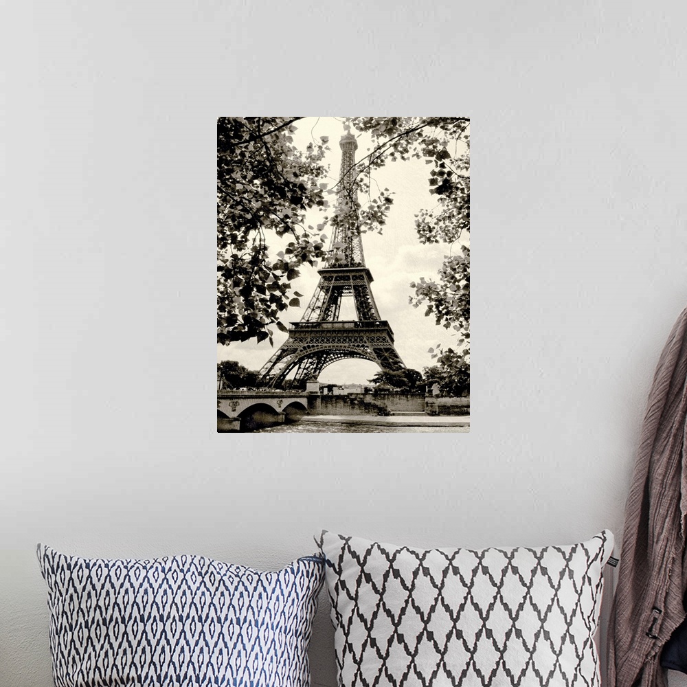 A bohemian room featuring Photograph of famous Paris, France monument with lake below and tree leaves hanging in the foregr...