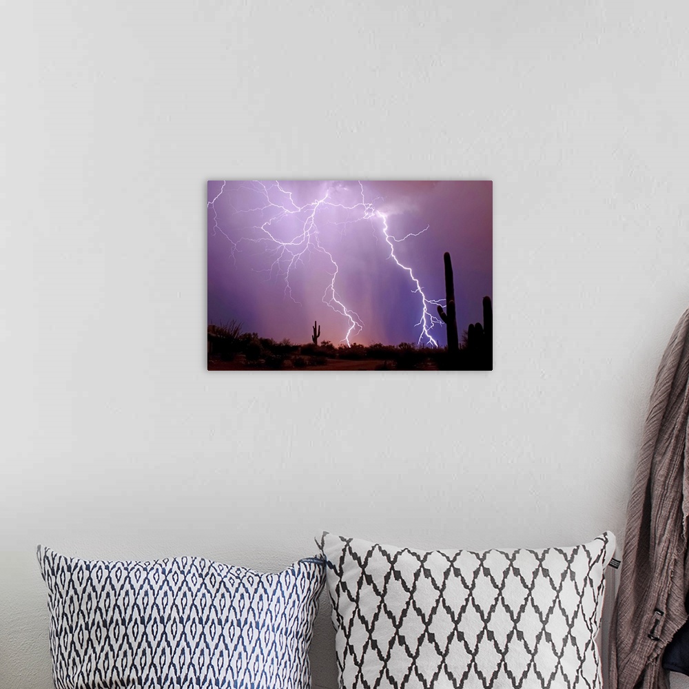 A bohemian room featuring Photograph of lightning bolts in a purple sky with a desert silhouette in the foreground.