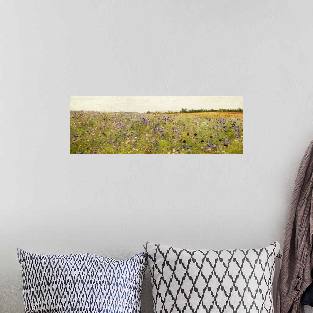 A bohemian room featuring Giant, panoramic painting of a vast field of wildflowers and tall grasses, beneath a clear sky.