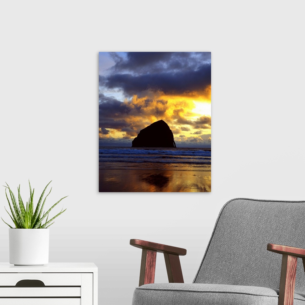A modern room featuring Silhouette photograph of a rock formation in the middle of the ocean with a colorful sunset in Or...