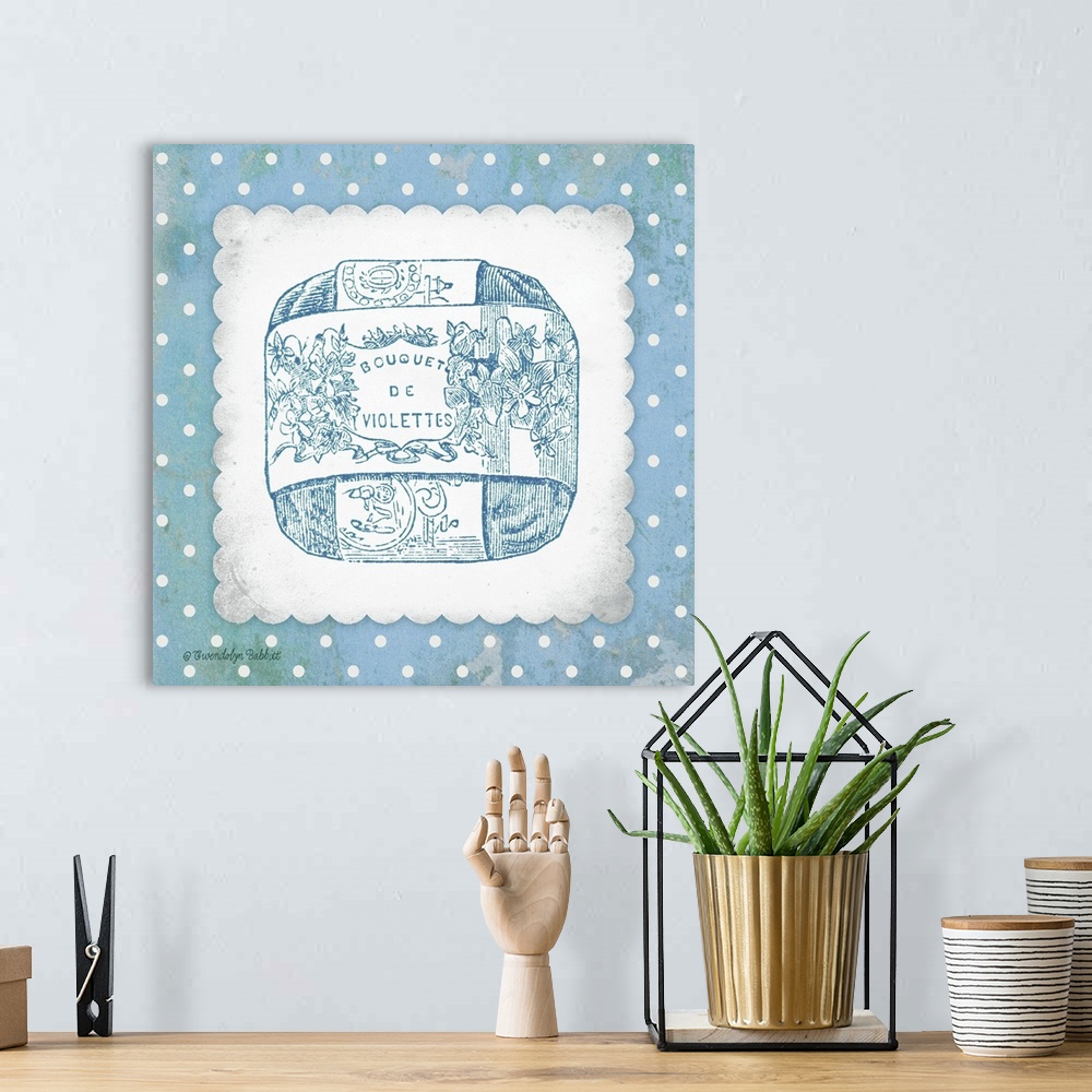 A bohemian room featuring Blue and white square bathroom art with an illustration of French bar soap.