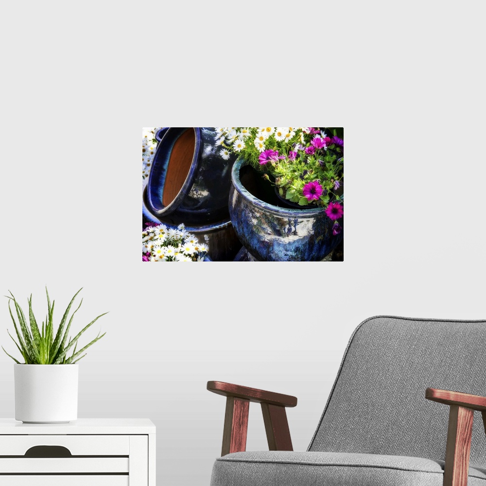 A modern room featuring Bouquets of flowers in silver pots.