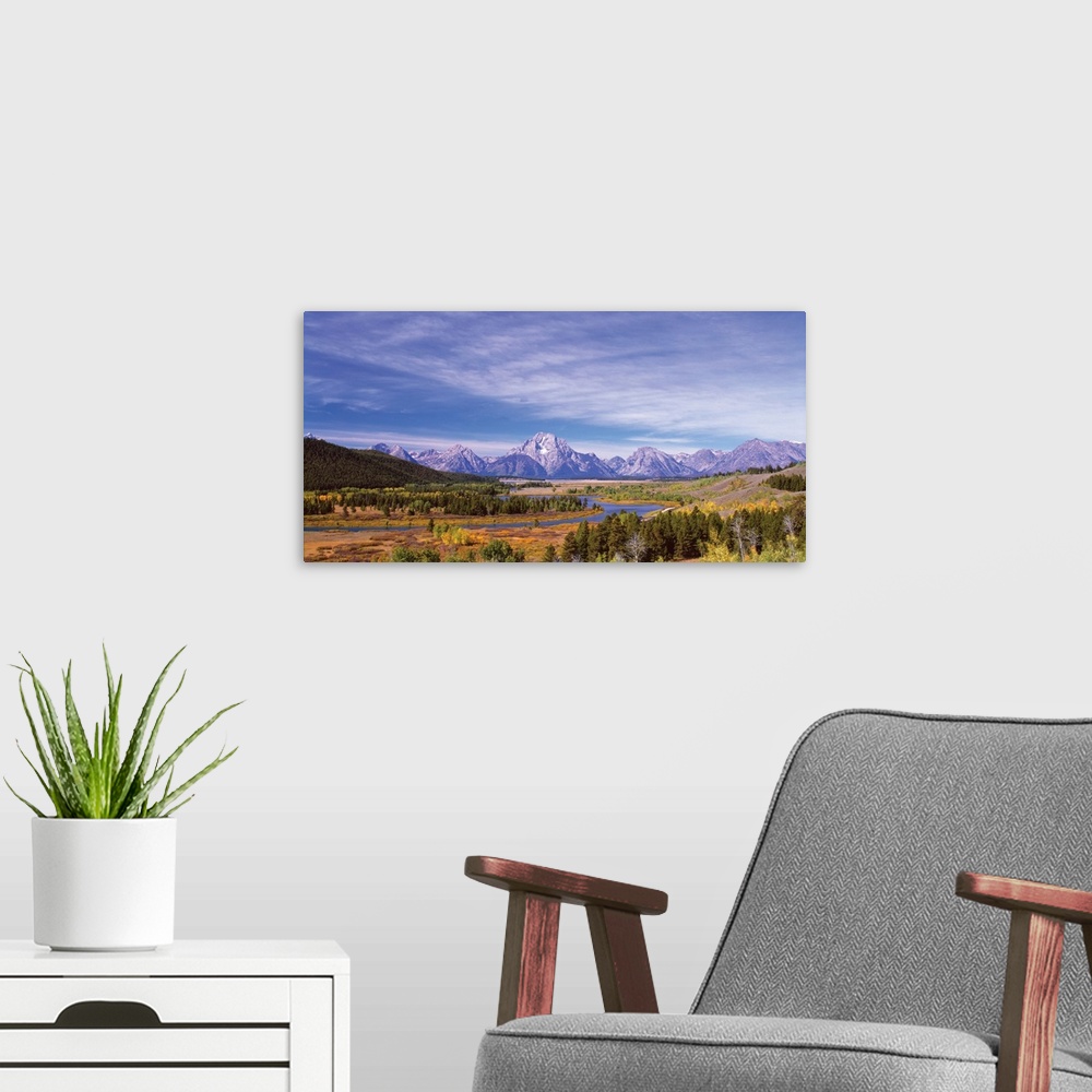 A modern room featuring View of the Grand Teton mountain range in the Wyoming wilderness.
