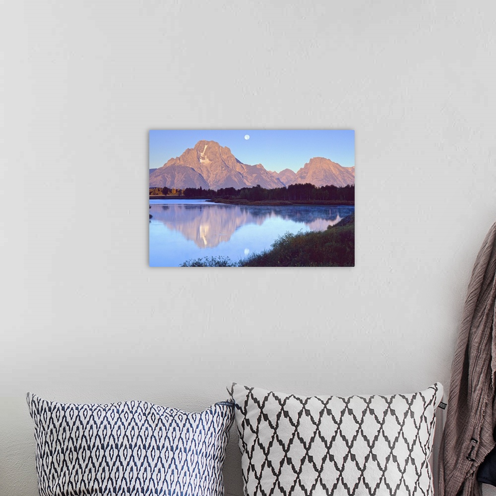 A bohemian room featuring The moon over the Grand Tetons in Wyoming, reflected in the lake below.