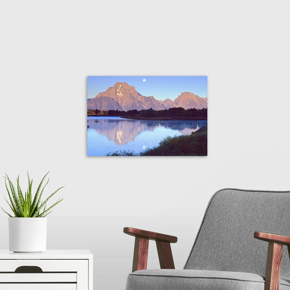 A modern room featuring The moon over the Grand Tetons in Wyoming, reflected in the lake below.