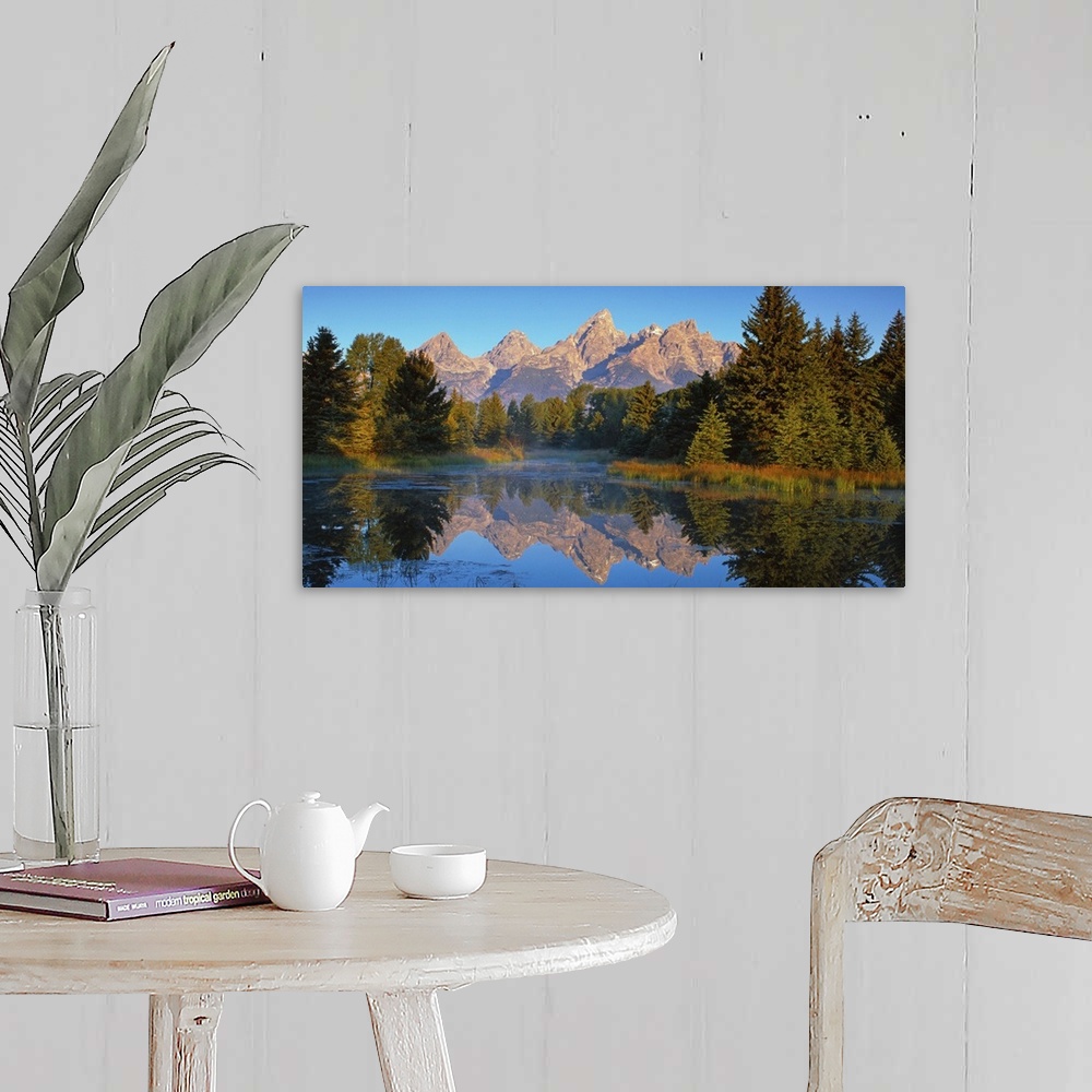 A farmhouse room featuring View of the Grand Teton Mountain range in Wyoming, reflected in a lake.