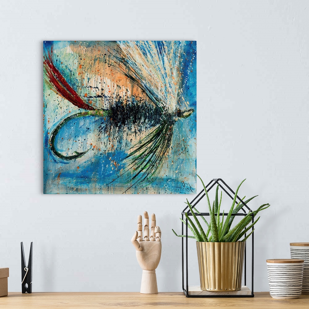 A bohemian room featuring Square painting of a green, red, and white fly fishing lure on a blue background with orange pain...