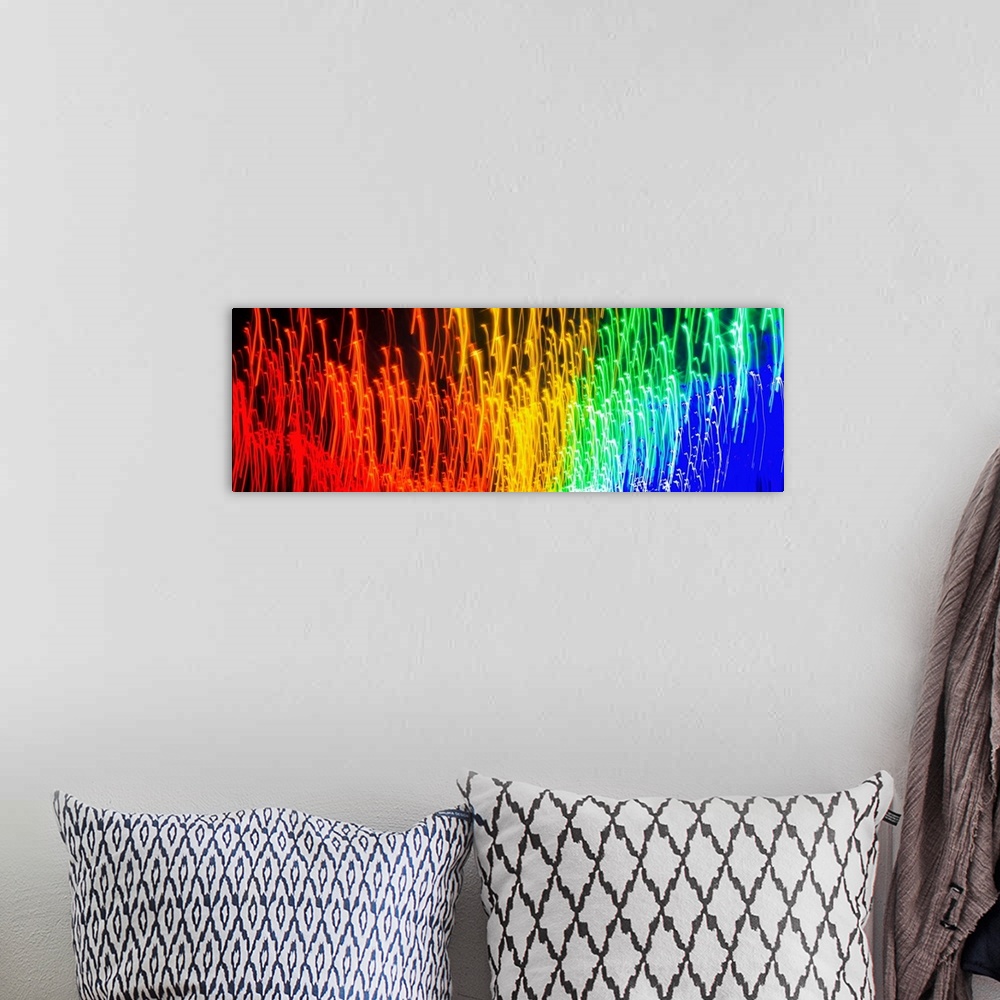 A bohemian room featuring Panoramic abstract photograph of rainbow light trails.