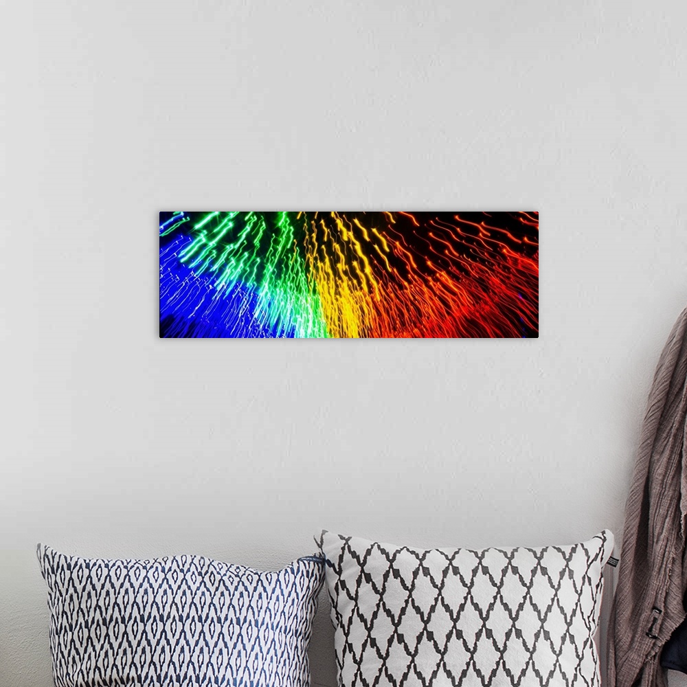 A bohemian room featuring Panoramic abstract photograph of rainbow light trails.
