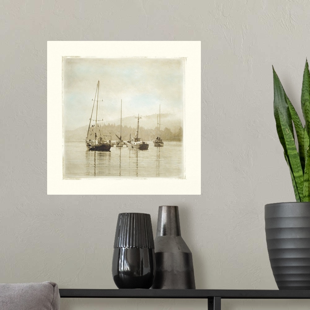 A modern room featuring Painting of sailboats sitting calmly in the harbor waters.