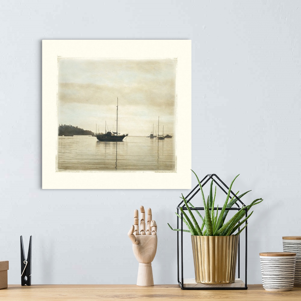 A bohemian room featuring Big canvas of a square picture of boats floating in calm water.