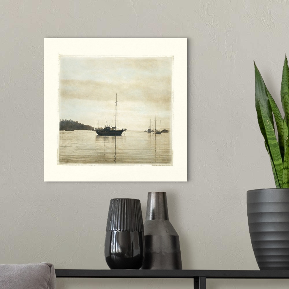 A modern room featuring Big canvas of a square picture of boats floating in calm water.