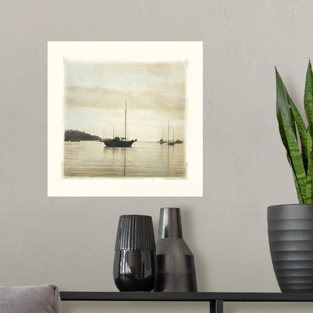A modern room featuring Big canvas of a square picture of boats floating in calm water.
