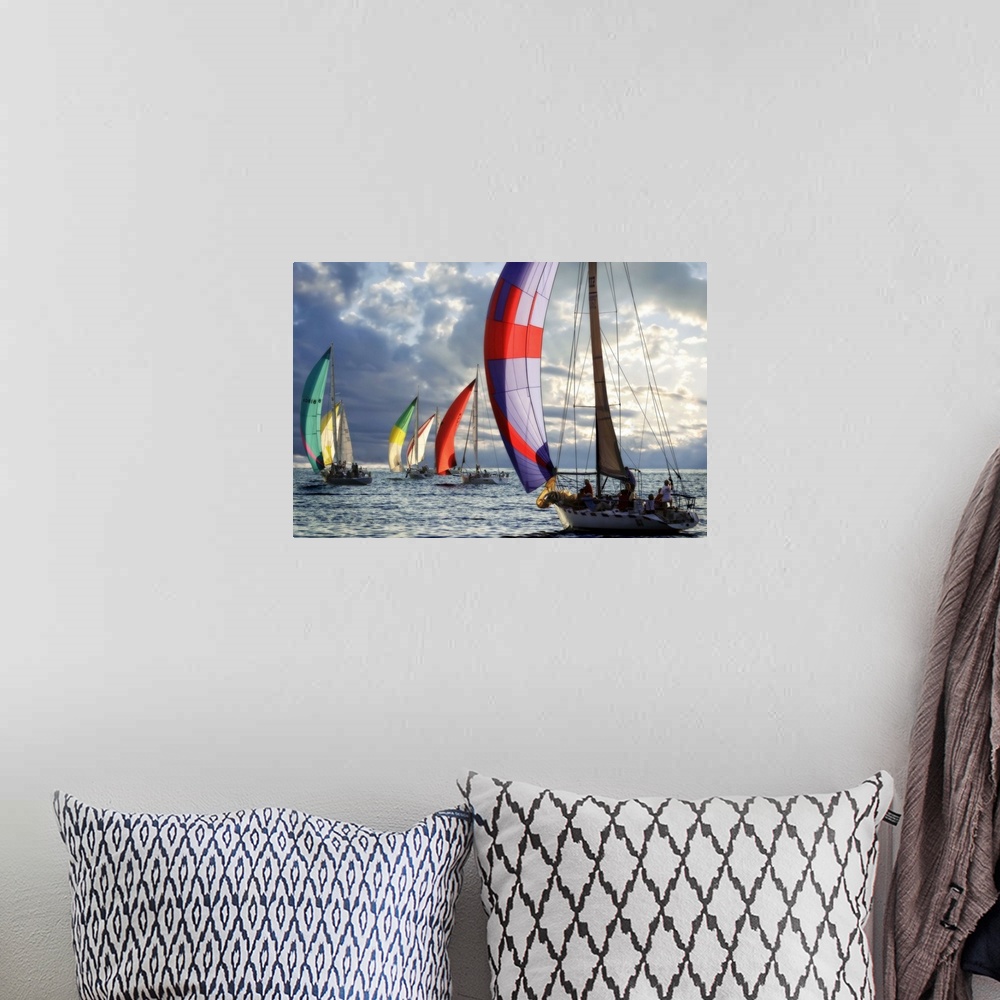 A bohemian room featuring Several sailboats with colorful sails under a cloudy sky in the evening.