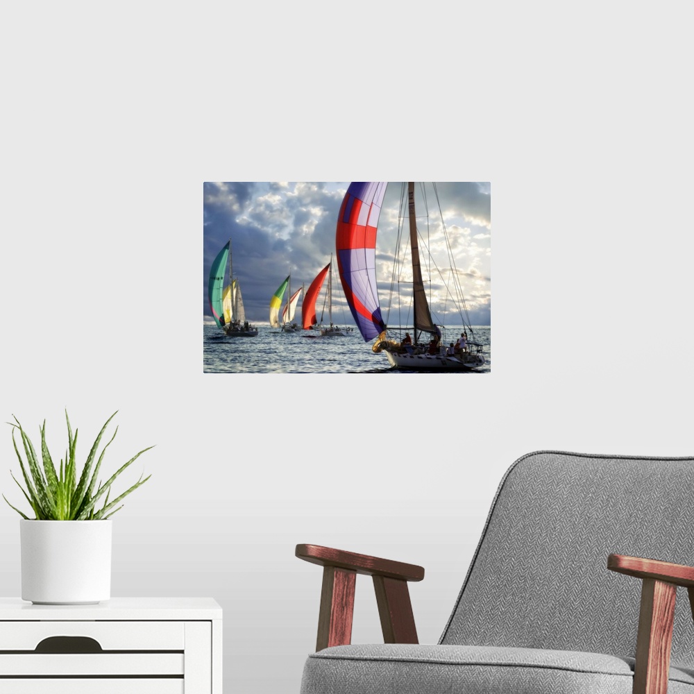 A modern room featuring Several sailboats with colorful sails under a cloudy sky in the evening.